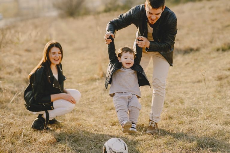 family kicking a soccer ball